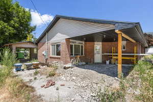 Rear view of house with brick siding