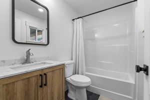 Full bath with vanity and shower / tub combo with curtain