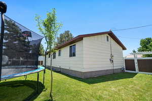 View of side of home featuring a trampoline
