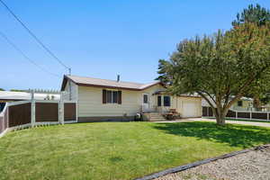 Ranch-style home with an attached garage and a metal roof