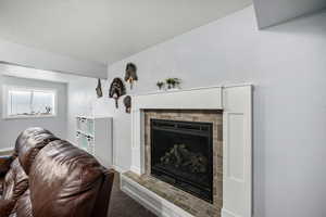 Living room with a fireplace and carpet flooring