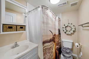 Full bath featuring vanity and a shower with curtain