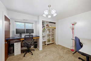 Office featuring carpet and a chandelier