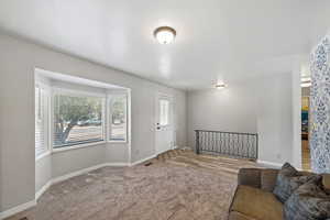Carpeted entryway featuring baseboards