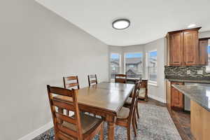Dining room with bay window and dark wood finish floors