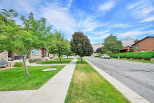 View of asphalt street with a mountain view and newer sidewalk