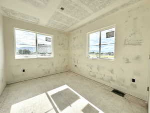 Unfurnished room with plenty of natural light