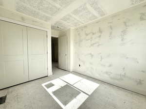 Unfurnished bedroom with a closet and baseboards