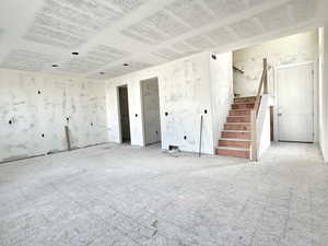 Unfurnished living room with stairway