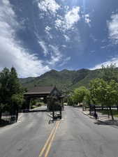 View of asphalt road featuring a mountain view, a gate, and a gated entry on East end