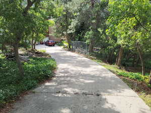 View of concrete driveway to 3 car garage. Plenty of parking with 30' x 30' dog run.