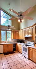 Kitchen with white appliances, high vaulted ceiling, under cabinet range hood, a ceiling fan, and tile countertops