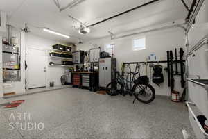 Garage featuring secured water heater and a garage door opener