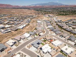 Aerial overview of property's location with a mountainous background and nearby suburban area