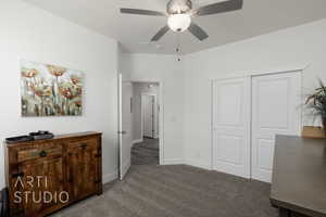Carpeted bedroom featuring a closet and a ceiling fan