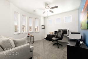 Office space with ceiling fan and carpet