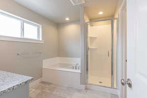 Full bath featuring a bath, a shower stall, recessed lighting, and vanity