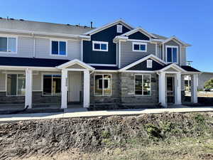 Craftsman-style home featuring stone siding and board and batten siding