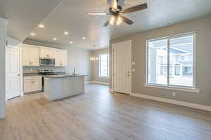Kitchen featuring appliances with stainless steel finishes, recessed lighting, a textured ceiling, a chandelier, and ceiling fan