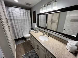 Bathroom featuring vanity, wood finished floors, and a shower with shower curtain