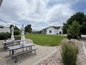 View of green lawn featuring a patio area