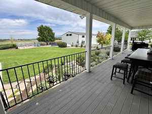 Wooden terrace with a playground and a lawn