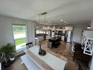 Dining space with a textured ceiling and recessed lighting