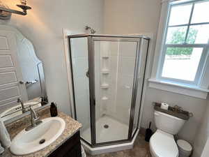 Full bathroom featuring vanity, a stall shower, plenty of natural light, and tile patterned floors