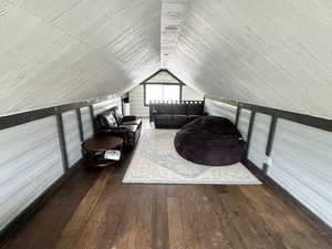Bonus room featuring hardwood / wood-style floors and lofted ceiling