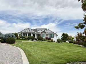 Craftsman-style house featuring a front yard