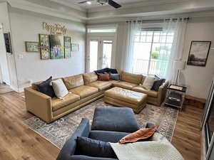 Living area featuring ornamental molding, wood finished floors, a ceiling fan, and recessed lighting