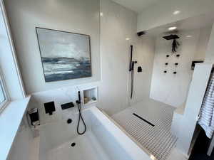 Full bathroom with a bath and a shower