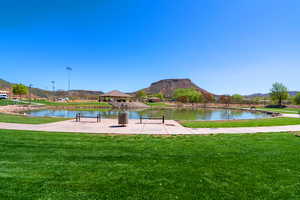 View of property's community with a yard, a water and mountain view, and a gazebo