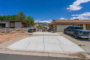 View of front of property with driveway, a garage, and brick siding