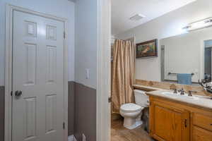 Full bathroom featuring tile patterned flooring, vanity, a shower with shower curtain, and a textured ceiling