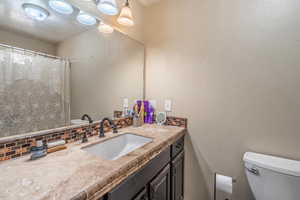 Bathroom featuring backsplash and vanity