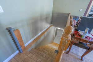 Stairs with baseboards and tile patterned floors