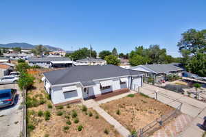 View of front of home featuring a residential view, concrete driveway, and a mountain view