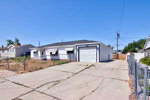 Single story home with driveway and a garage