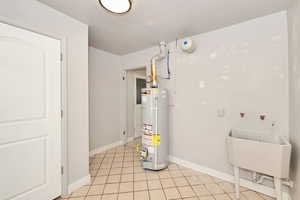 Utilities with gas water heater and a sink