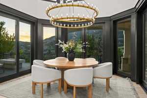 Dining area featuring a chandelier, wood finished floors, french doors, and a mountain view
