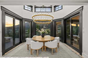 Dining room featuring a chandelier and a towering ceiling