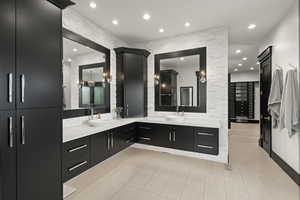 Full bath featuring double vanity and recessed lighting
