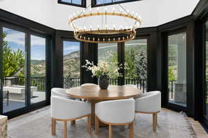 Dining room featuring a chandelier, a mountain view, and wood finished floors
