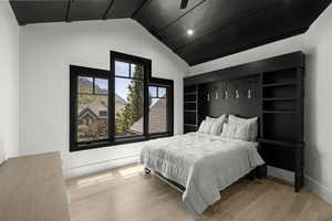 Bedroom featuring vaulted ceiling and wood finished floors