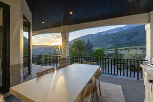 Balcony featuring a mountain view and outdoor dining area