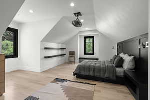 Bedroom featuring light wood-style floors, lofted ceiling, and recessed lighting
