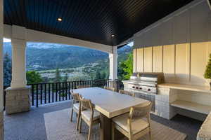 View of patio with exterior kitchen and outdoor dining area