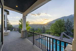 Balcony with a mountain view and view of pool