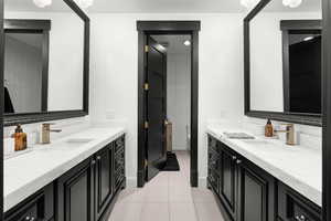 Bathroom featuring two vanities and tile patterned flooring